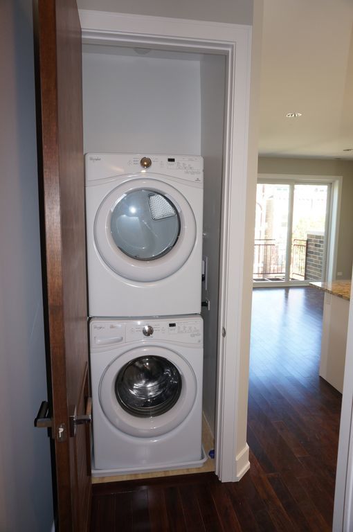 Undisclosed Address Chicago, IL 60608 - Photo 4 of 5 a utility room with wooden floor washer and dryer