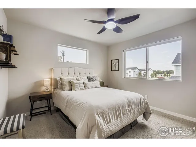 a bedroom with a bed and a painting on the wall