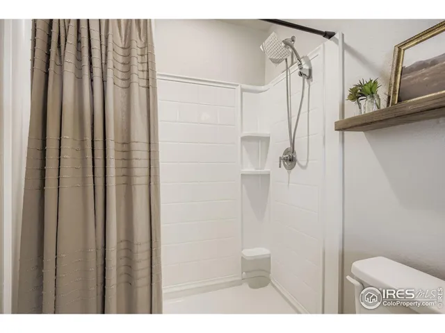 a bathroom with a shower a toilet and sink