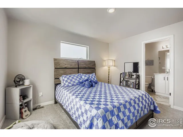 a bedroom with a large bed and a tv