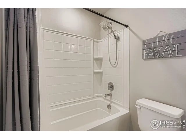 a bathroom with a shower a bath tub and a shower curtain