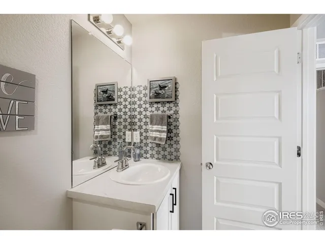 a bathroom with a sink a mirror and shower