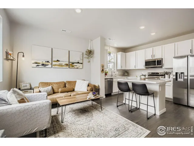 a living room with furniture and kitchen view