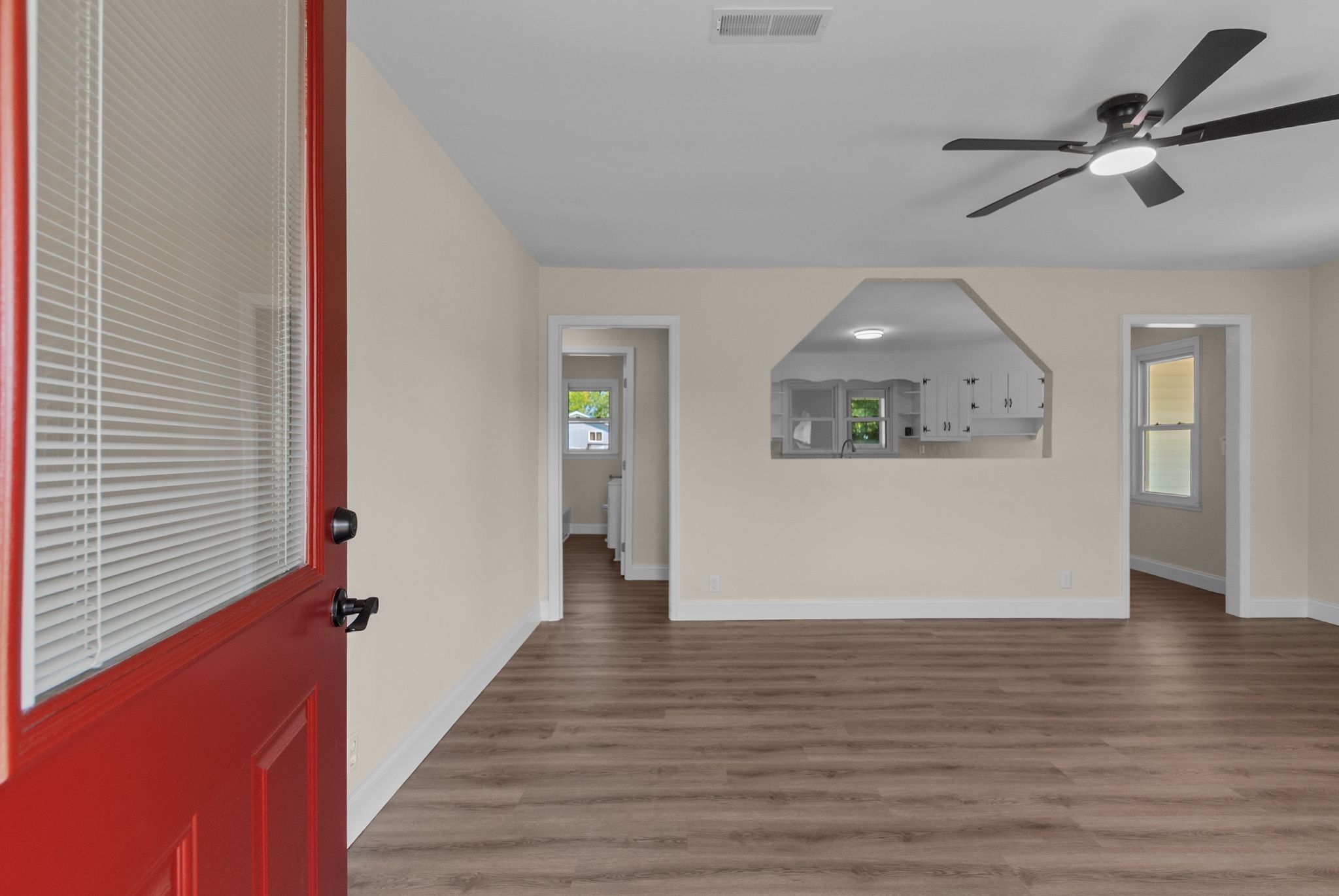 731 Smith Avenue Hohenwald, TN 38462 - Photo 1 of 28 a view of a hallway with wooden floor and a ceiling fan