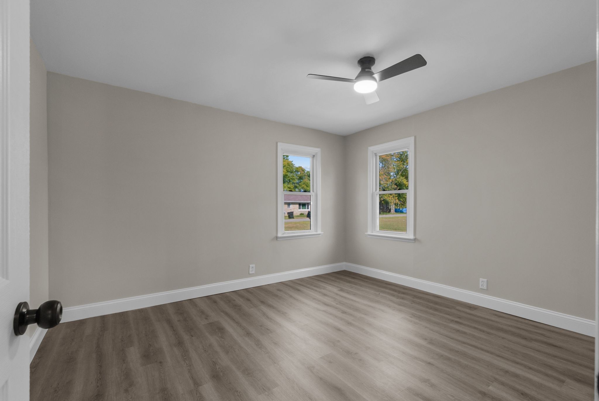 731 Smith Avenue Hohenwald, TN 38462 - Photo 12 of 28 wooden floor in an empty room with a window