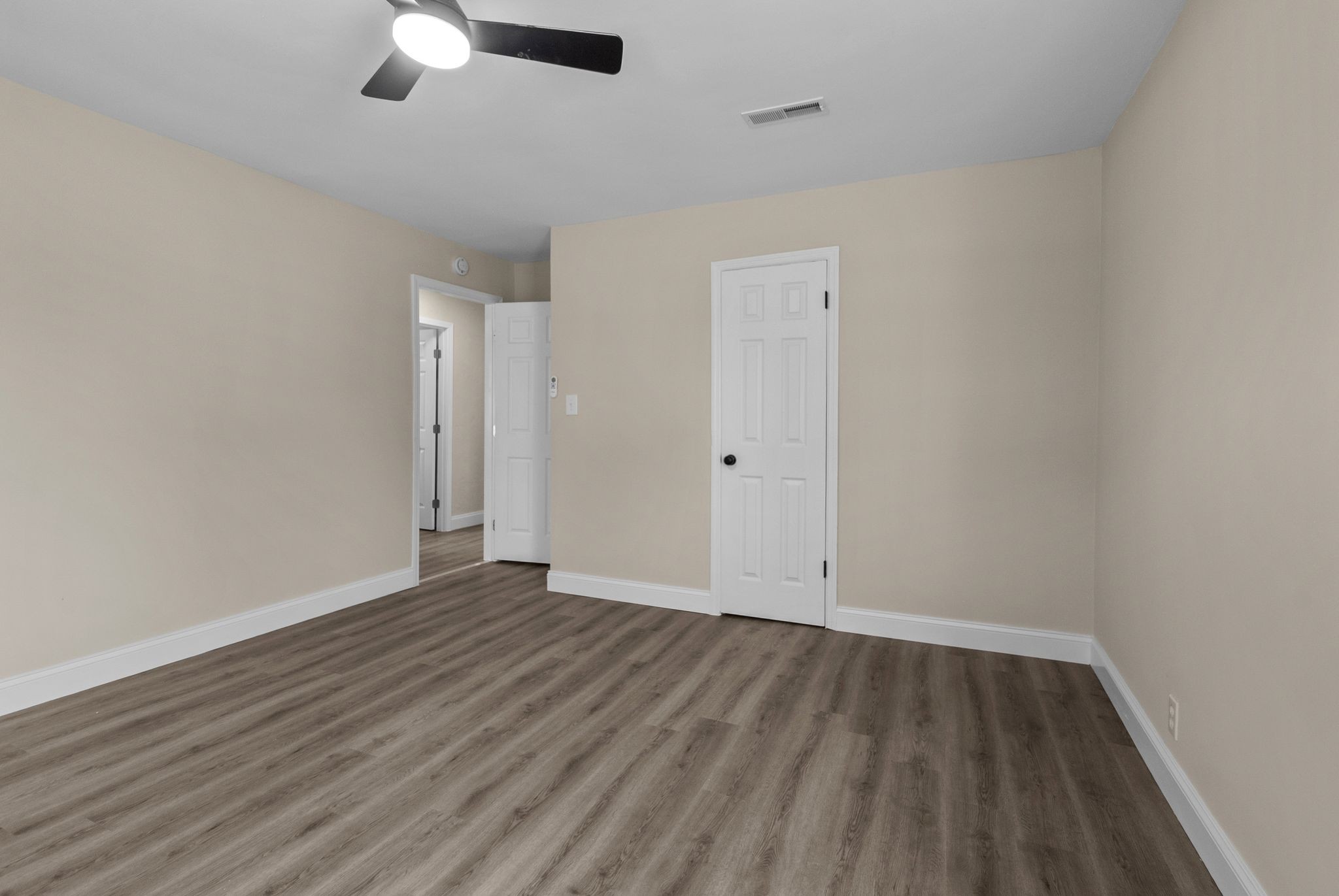 731 Smith Avenue Hohenwald, TN 38462 - Photo 14 of 28 an empty room with wooden floor cabinet and windows