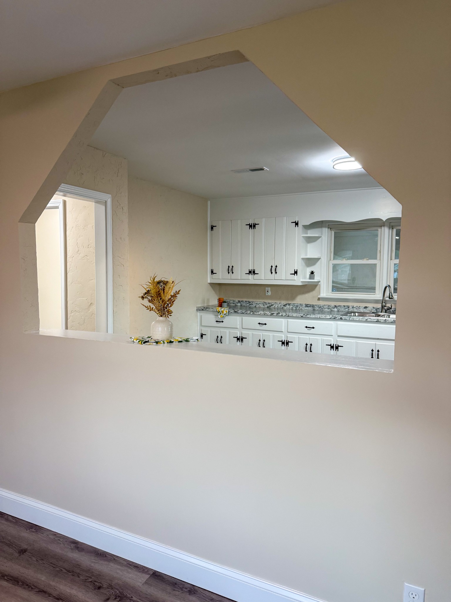 731 Smith Avenue Hohenwald, TN 38462 - Photo 17 of 28 a room with kitchen island a stove a sink and a window