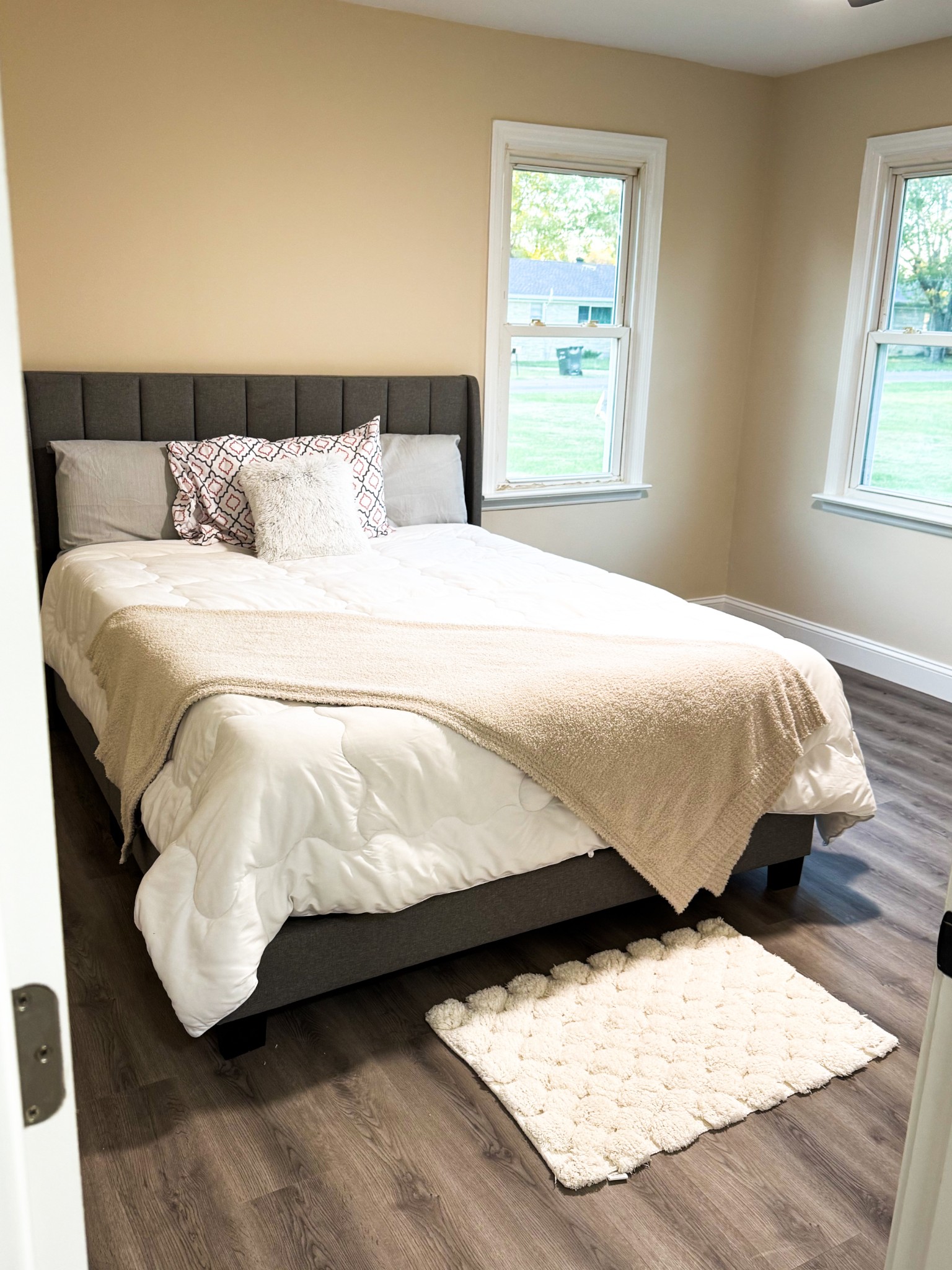 731 Smith Avenue Hohenwald, TN 38462 - Photo 21 of 28 a bed sitting in a bedroom next to a window with lamp