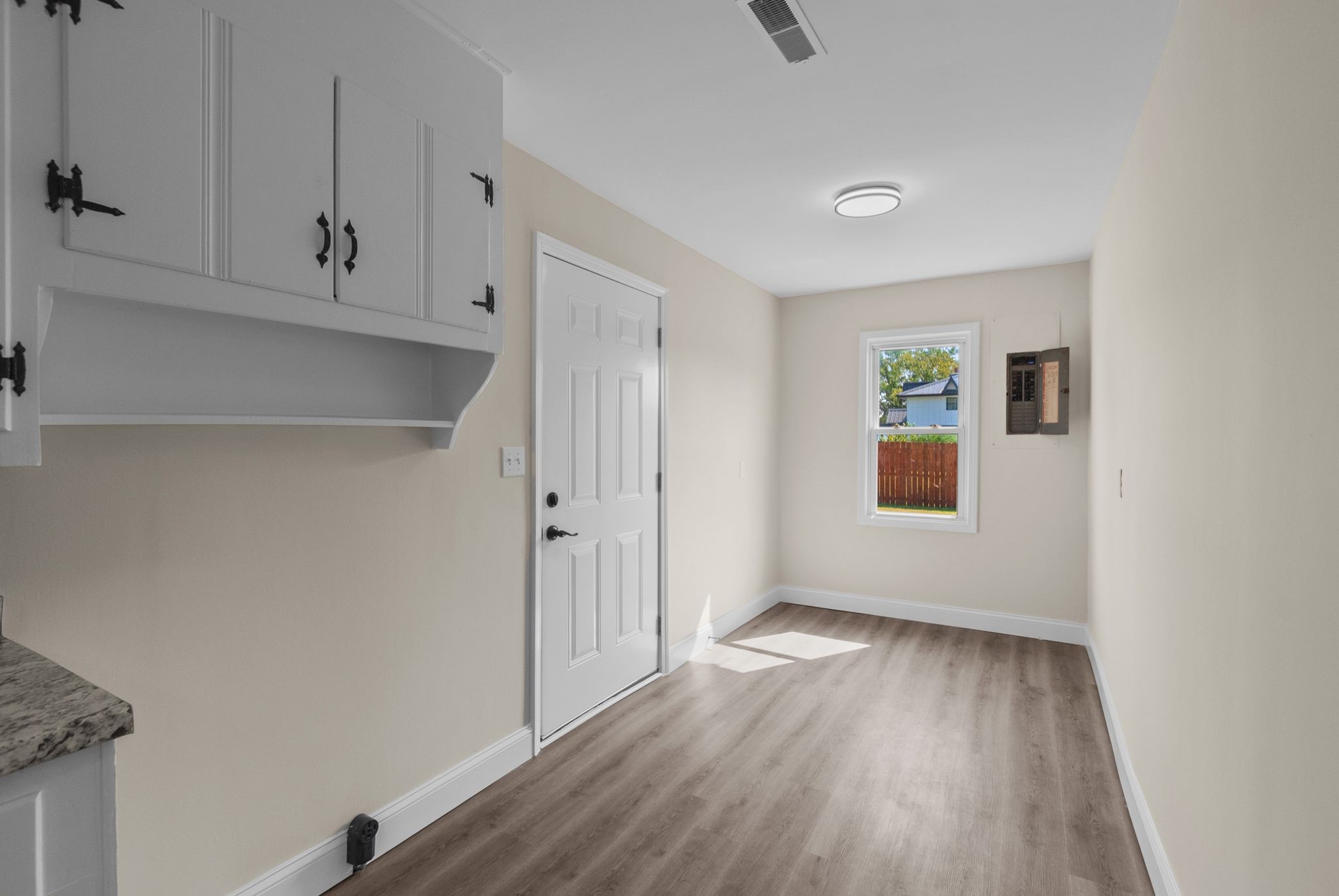 731 Smith Avenue Hohenwald, TN 38462 - Photo 23 of 28 a view of an empty room with wooden floor and a window