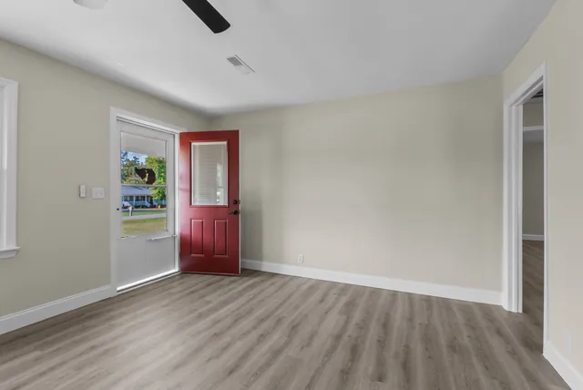 a living room with furniture and floor to ceiling window