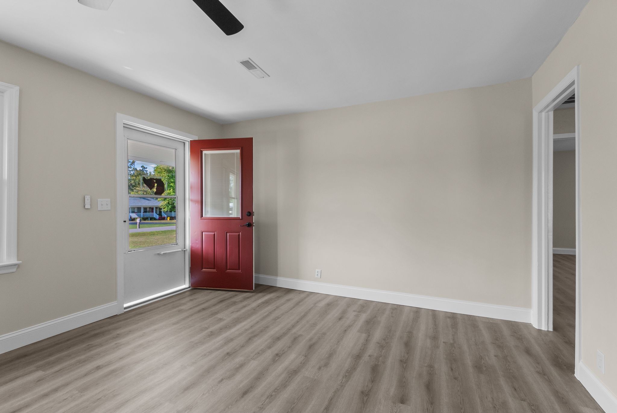 731 Smith Avenue Hohenwald, TN 38462 - Photo 6 of 28 wooden floor in an empty room with a window