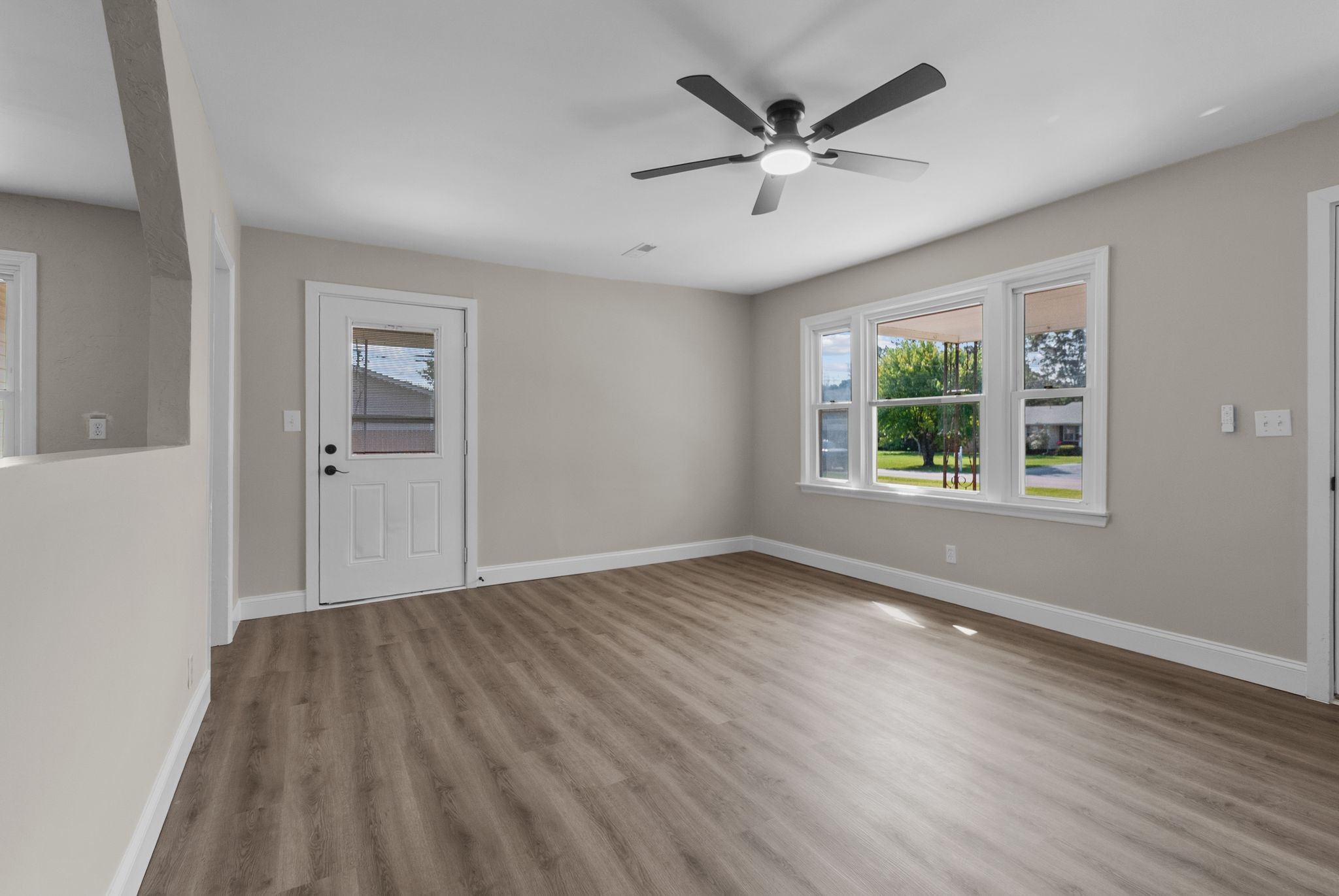 731 Smith Avenue Hohenwald, TN 38462 - Photo 8 of 28 wooden floor in an empty room with a window
