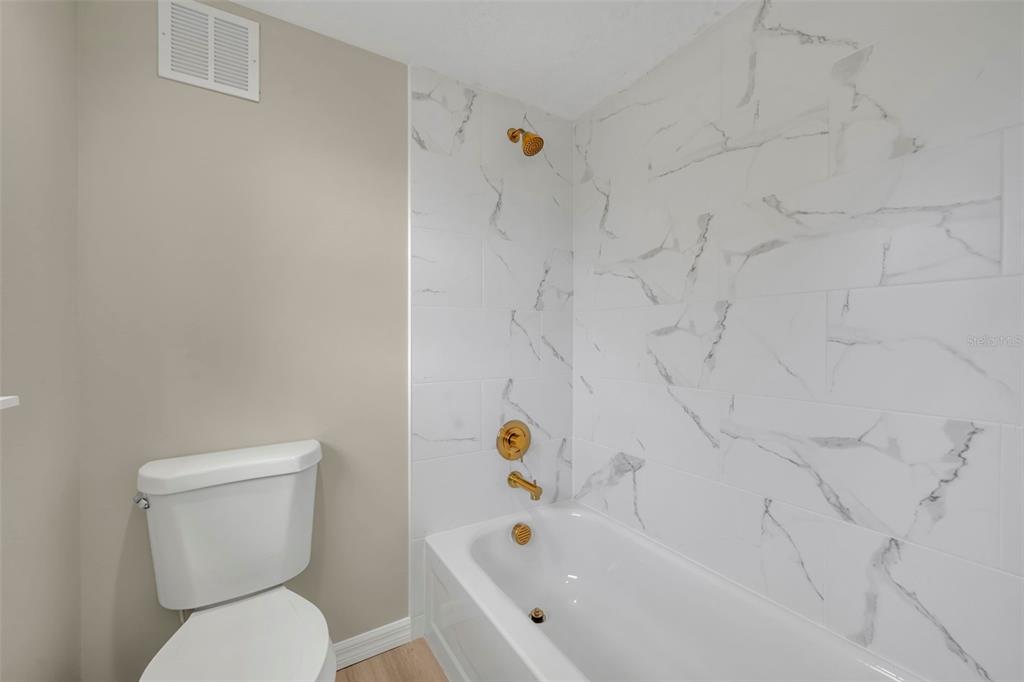 31201 Merry Road Tavares, FL 32778 - Photo 36 of 40 a bathroom with a toilet and a tub