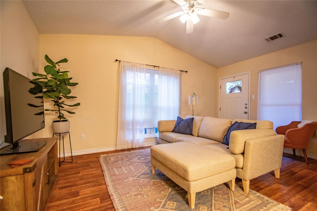 1817 Lipscomb Street Fort Worth, TX 76110 - Photo 2 of 10 Living room featuring lofted ceiling, ceiling fan, and dark wood-type flooring