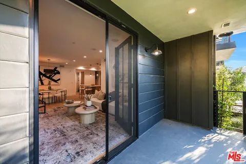 a view of a hallway with a dining room and bathroom