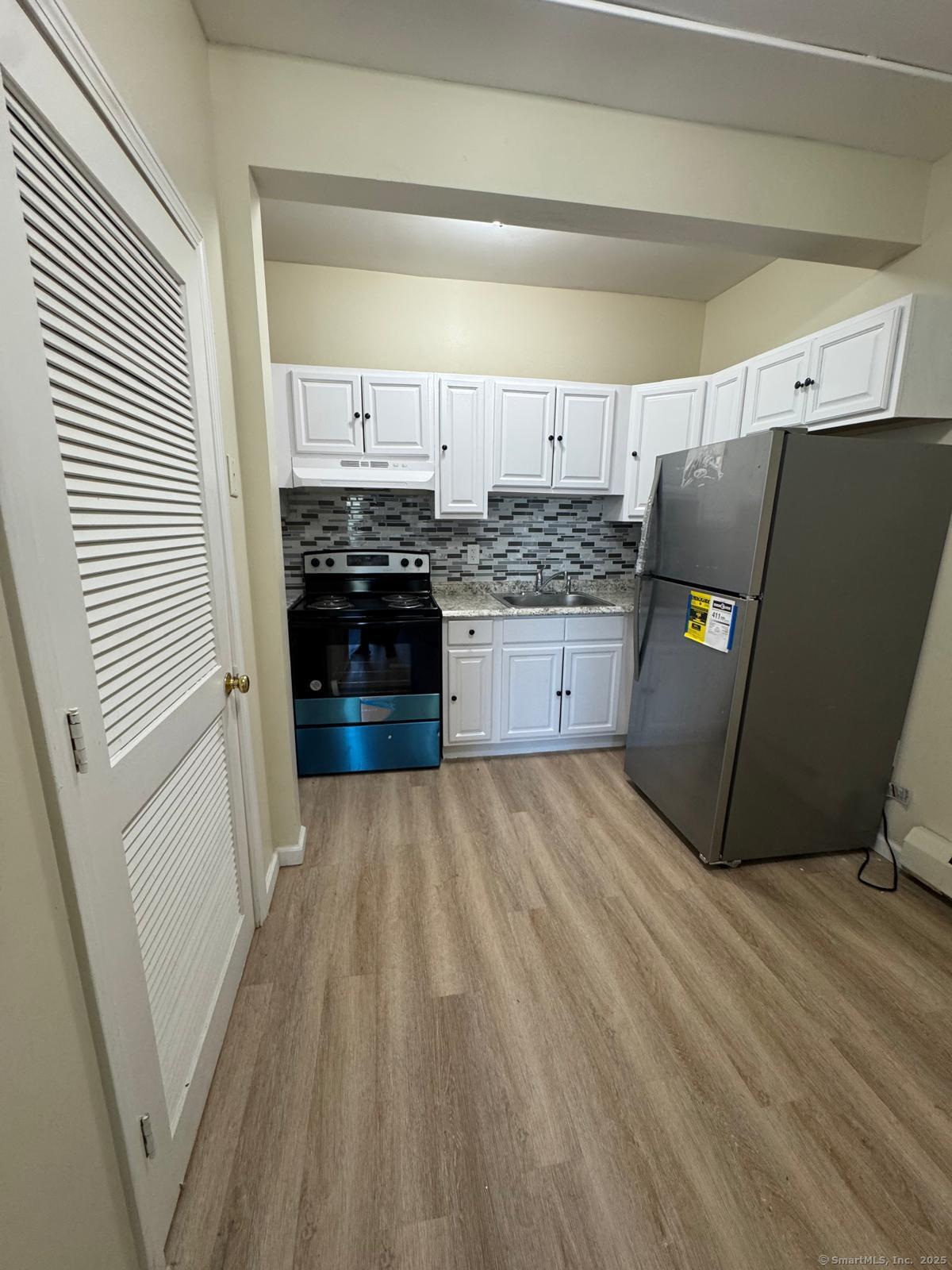 a kitchen with a sink and a stove top oven