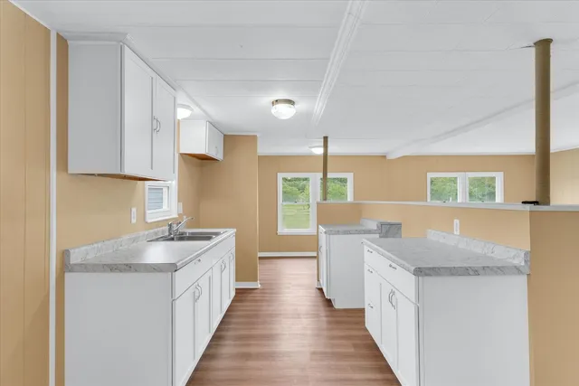 a kitchen with a sink stove and wooden cabinets