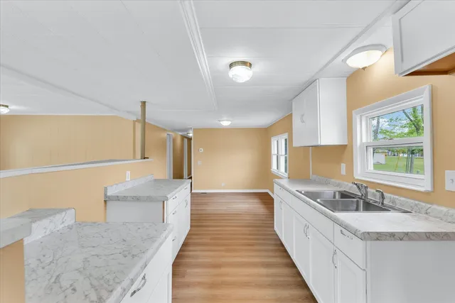 a large bathroom with a large tub sink and mirror