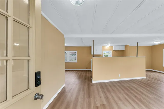 a view of a kitchen with furniture and wooden floor