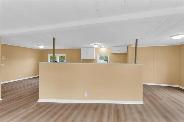 a view of a kitchen with furniture and wooden floor
