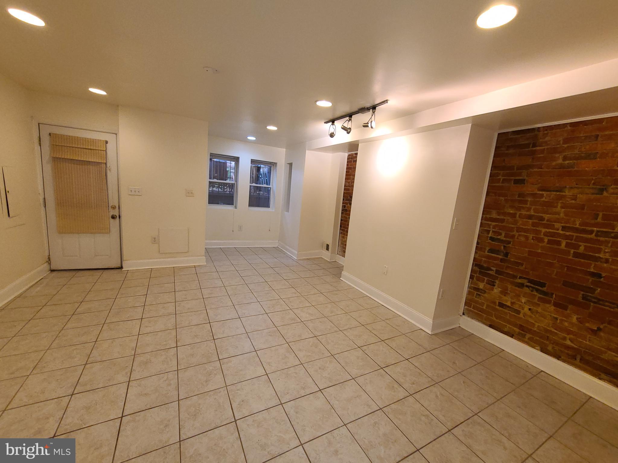 1037 5th Street Northeast, Unit B Washington, DC 20002 - Photo 3 of 13 an empty room with kitchen view