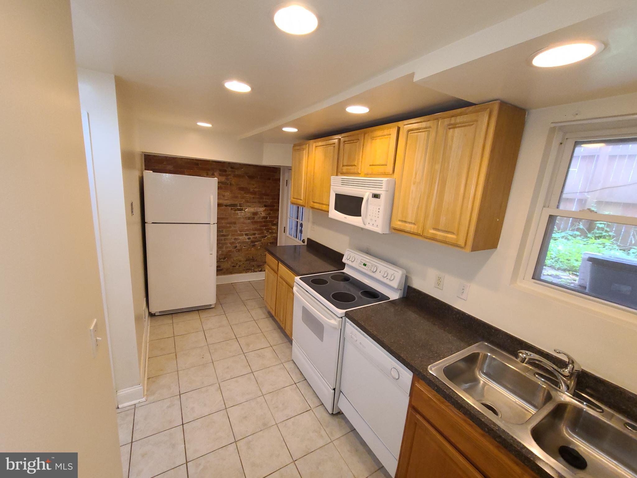 1037 5th Street Northeast, Unit B Washington, DC 20002 - Photo 4 of 13 a kitchen with a sink appliances and cabinets
