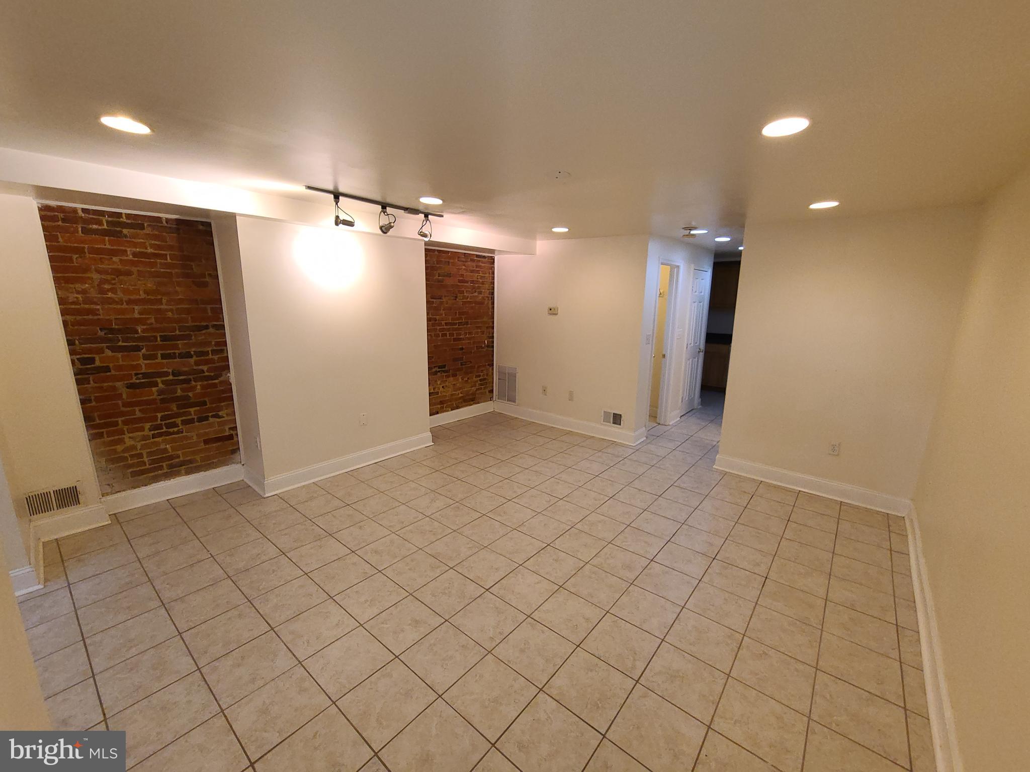1037 5th Street Northeast, Unit B Washington, DC 20002 - Photo 5 of 13 an empty room with white walls and tiles
