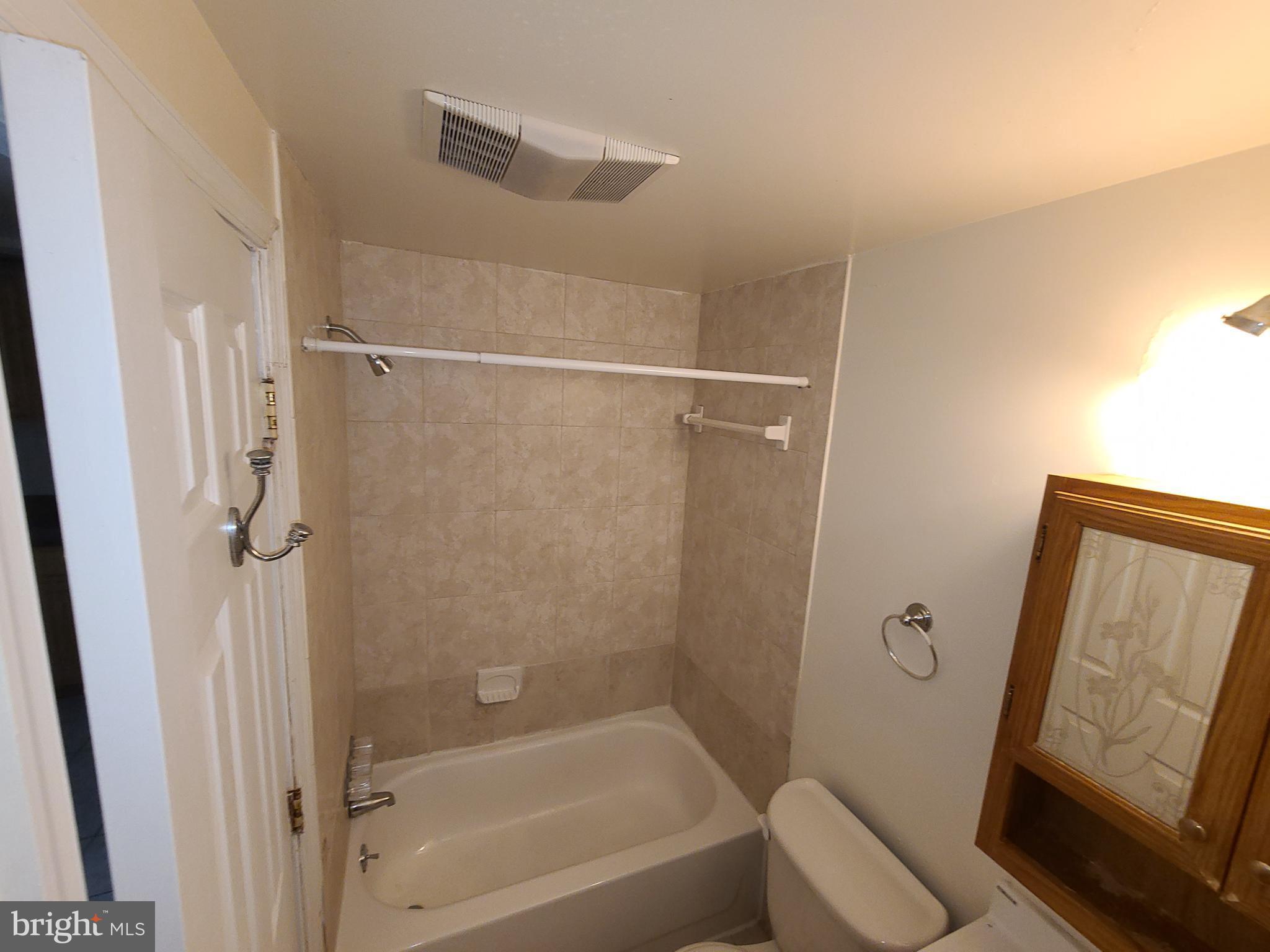 1037 5th Street Northeast, Unit B Washington, DC 20002 - Photo 7 of 13 a bathroom with a tub shower vanity and a sink