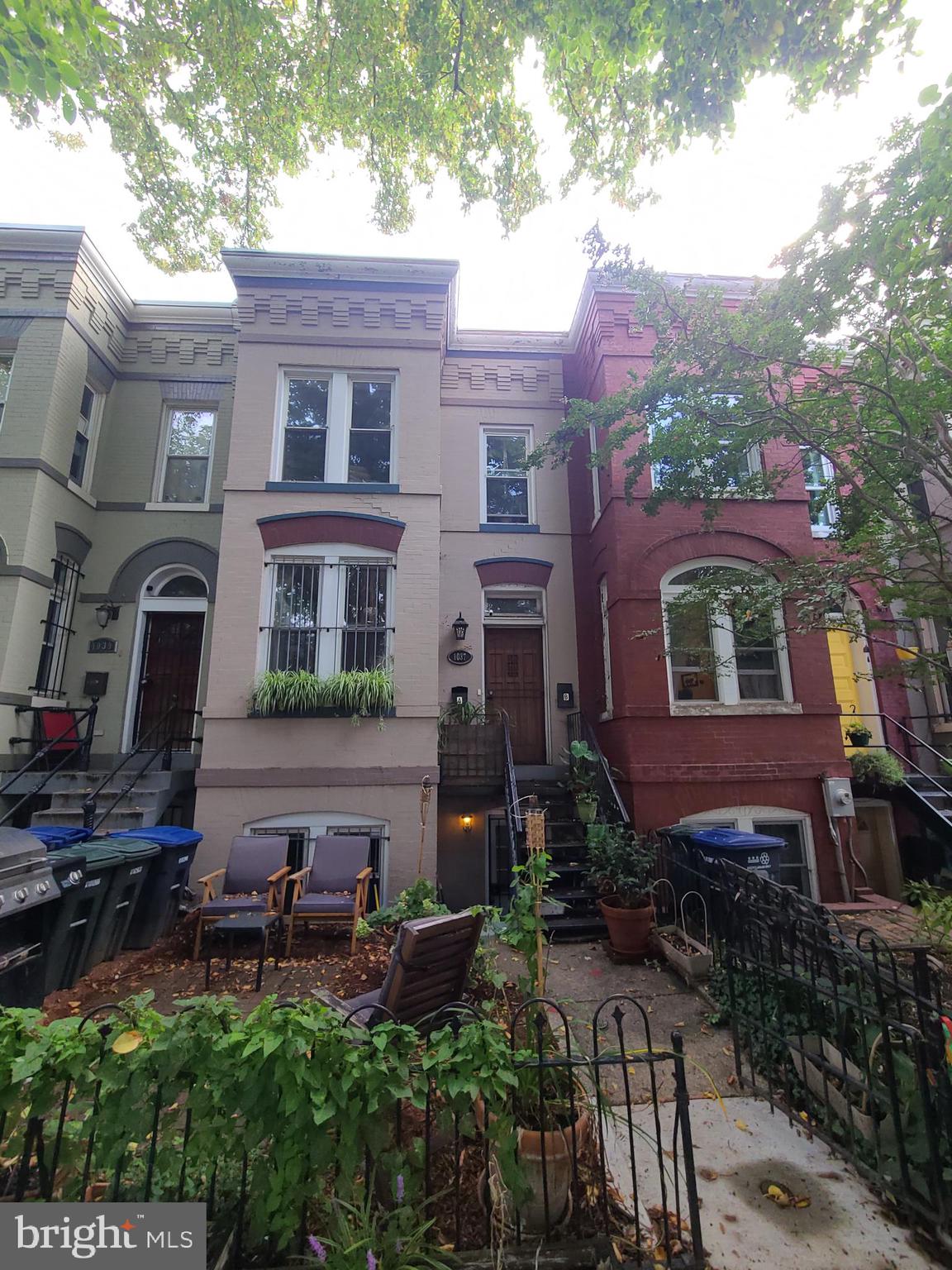 1037 5th Street Northeast, Unit B Washington, DC 20002 - Photo 9 of 13 a backyard of a house with table and chairs