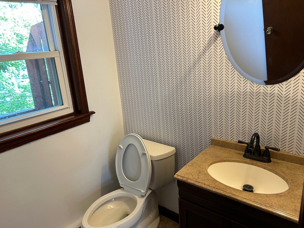 67 Everard Street Worcester, MA 01605 - Photo 6 of 13 a bathroom with a toilet a sink and a mirror