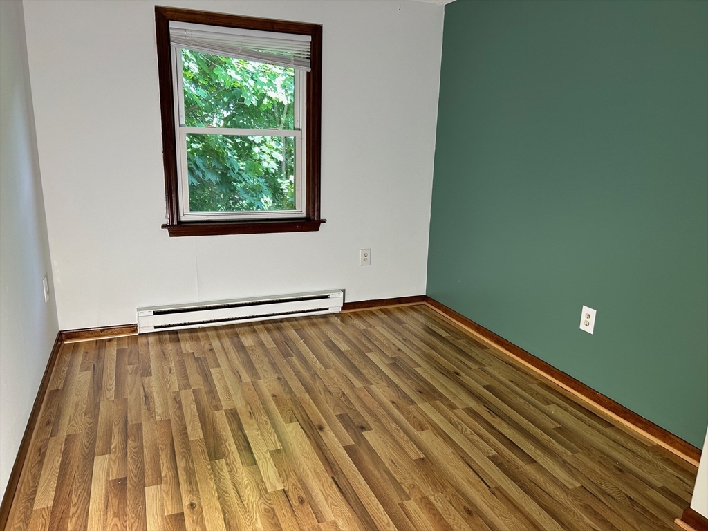 67 Everard Street Worcester, MA 01605 - Photo 8 of 13 a view of empty room with wooden floor and fan