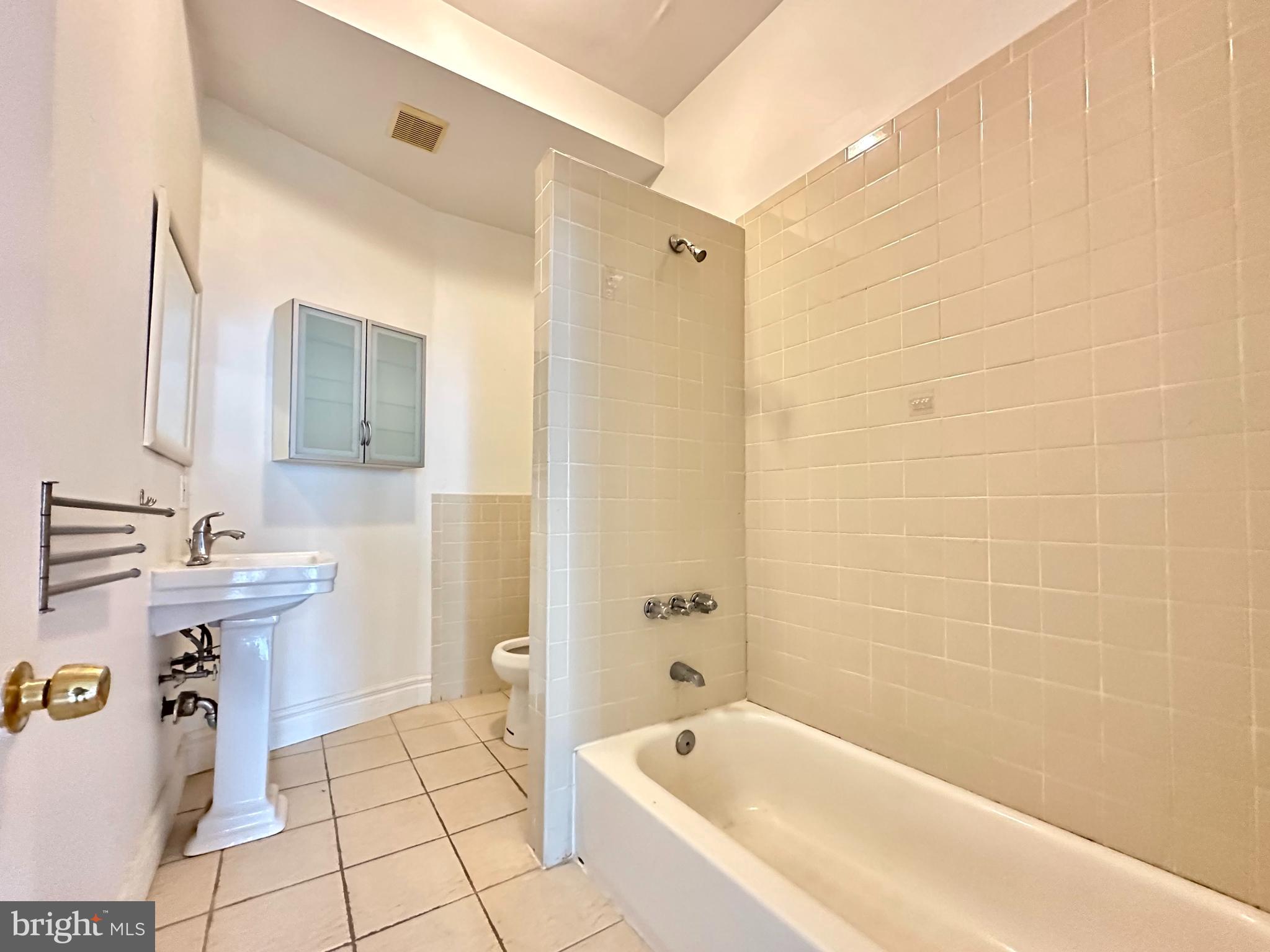 1214 North 5th Street, Unit 2 Philadelphia, PA 19122 - Photo 12 of 17 a bathroom with a sink mirror toilet and bathtub