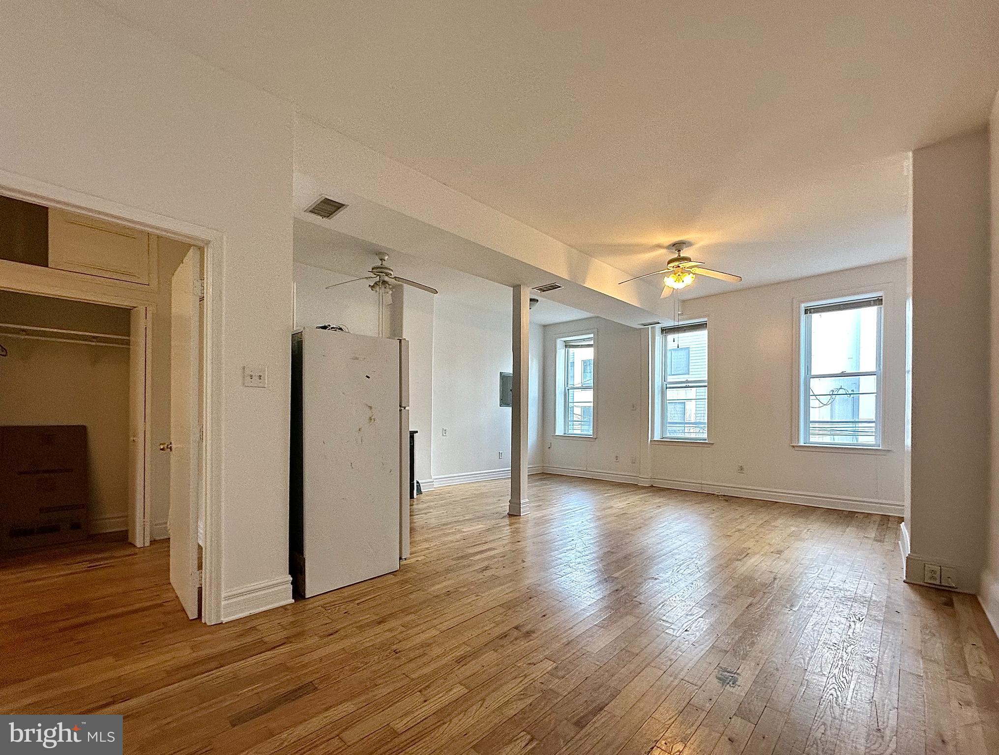 1214 North 5th Street, Unit 2 Philadelphia, PA 19122 - Photo 2 of 17 a view of livingroom with hardwood floor and window
