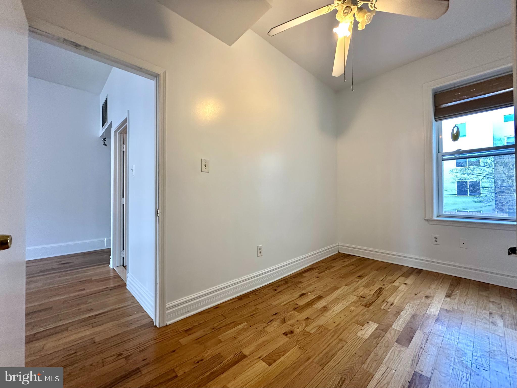 1214 North 5th Street, Unit 2 Philadelphia, PA 19122 - Photo 9 of 17 a view of empty room with wooden floor and fan