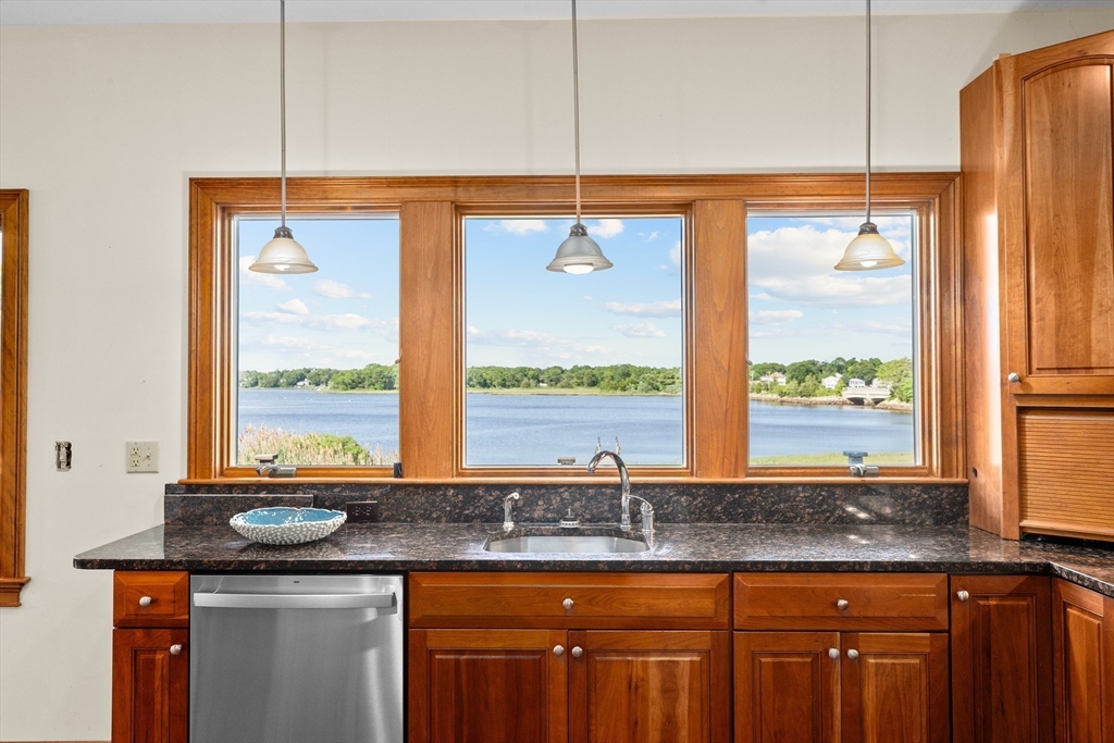 17 River Road Marion, MA 02738 - Photo 15 of 36 a kitchen with stainless steel appliances granite countertop a sink and a large window