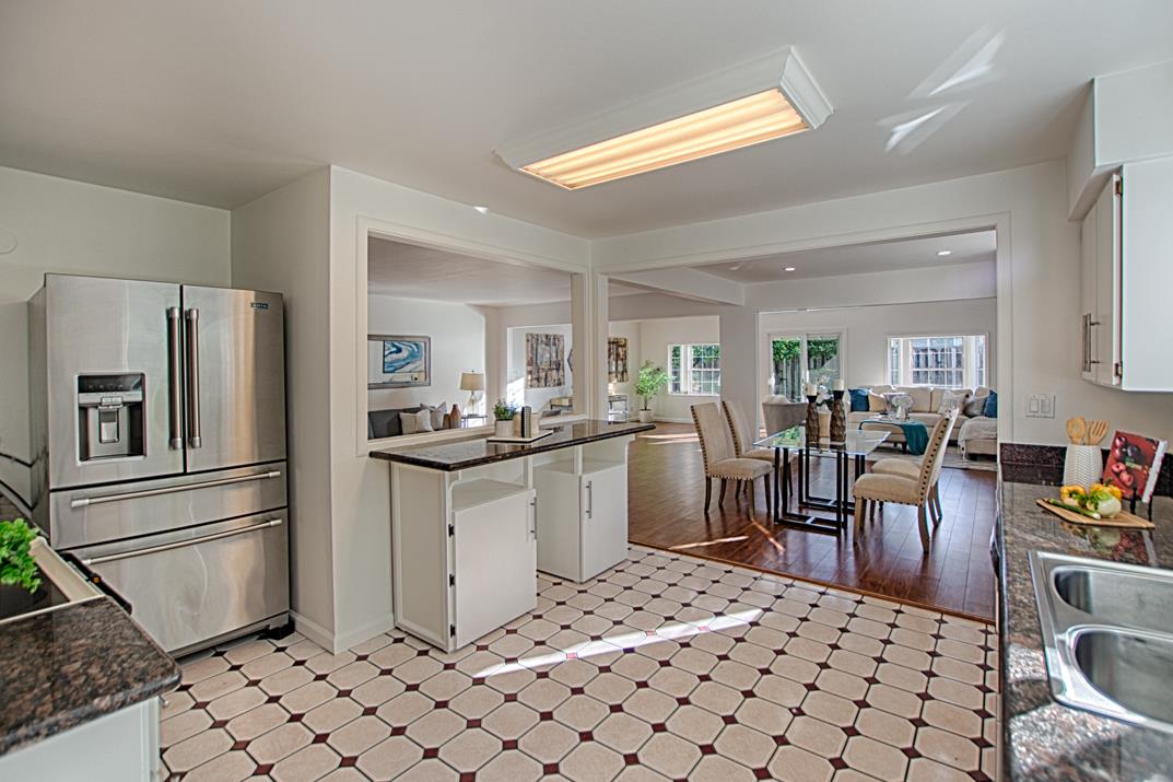 1663 Spring Street Mountain View, CA 94043 - Photo 14 of 31 a kitchen with stainless steel appliances kitchen island granite countertop a refrigerator and a stove top oven