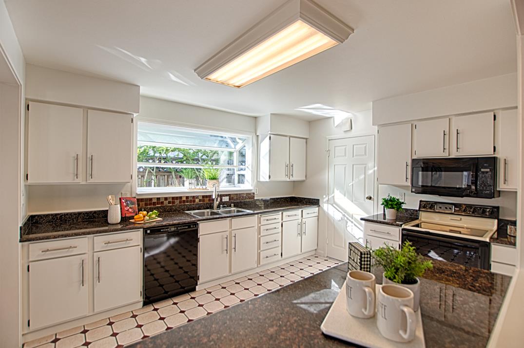 1663 Spring Street Mountain View, CA 94043 - Photo 15 of 31 a kitchen with granite countertop a stove a sink and a microwave
