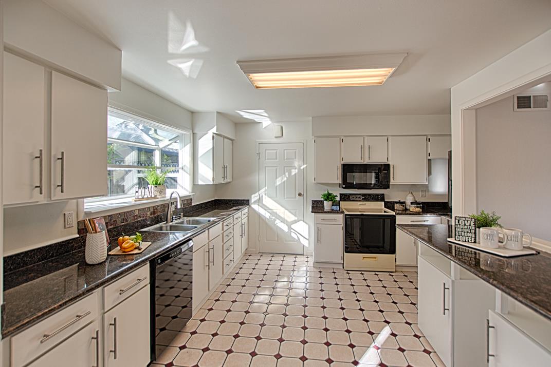 1663 Spring Street Mountain View, CA 94043 - Photo 16 of 31 a kitchen with granite countertop a stove a sink and a microwave