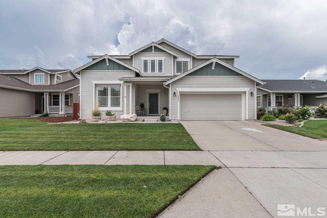 8921 Sorcha Street Reno, NV 89506 - Photo 1 of 35 a front view of a house with a big yard and potted plants