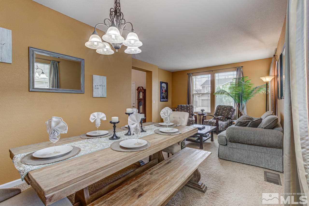 8921 Sorcha Street Reno, NV 89506 - Photo 17 of 35 a view of a dining room with furniture wooden floor and chandelier