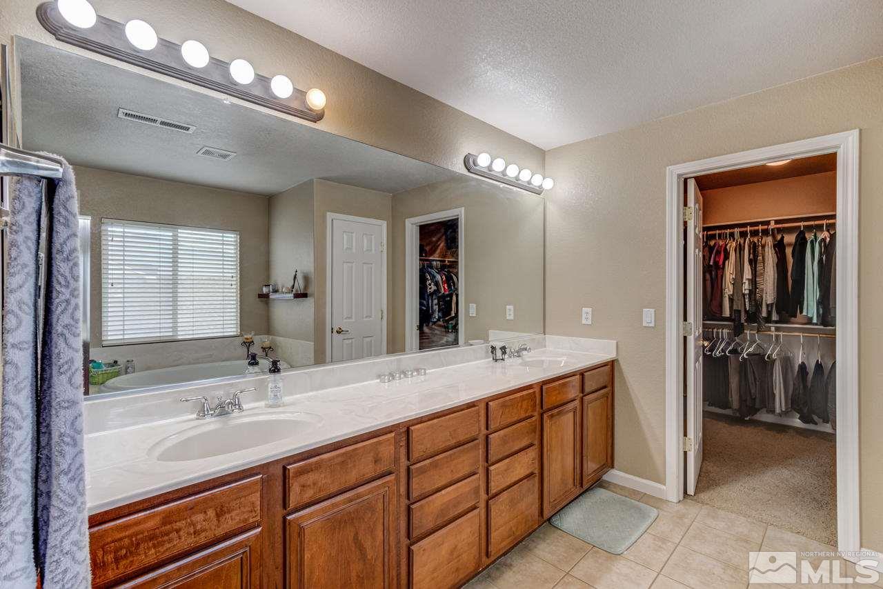 8921 Sorcha Street Reno, NV 89506 - Photo 23 of 35 a bathroom with double sink and a mirror