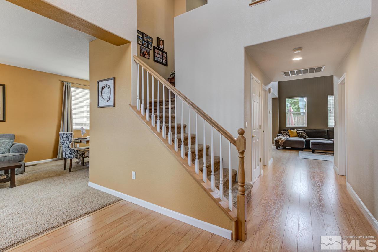 8921 Sorcha Street Reno, NV 89506 - Photo 5 of 35 a view of a hallway with wooden floor and stairs