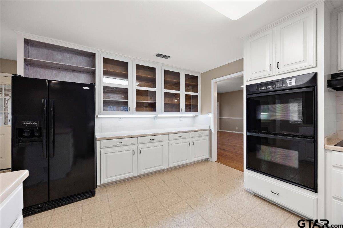 142 Parrish Rusk, TX 75785 - Photo 11 of 43 a kitchen with granite countertop white cabinets and refrigerator