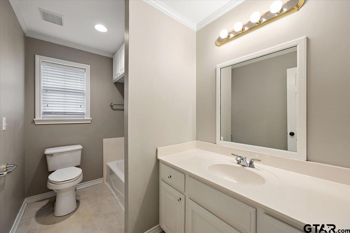 142 Parrish Rusk, TX 75785 - Photo 20 of 43 a bathroom with a toilet sink double vanity and mirror