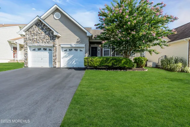 a front view of a house with a yard and garage