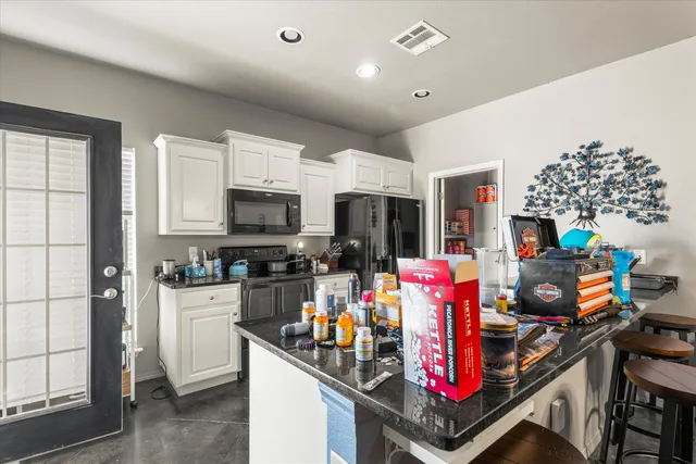 a kitchen that has a lot of appliances and cabinets