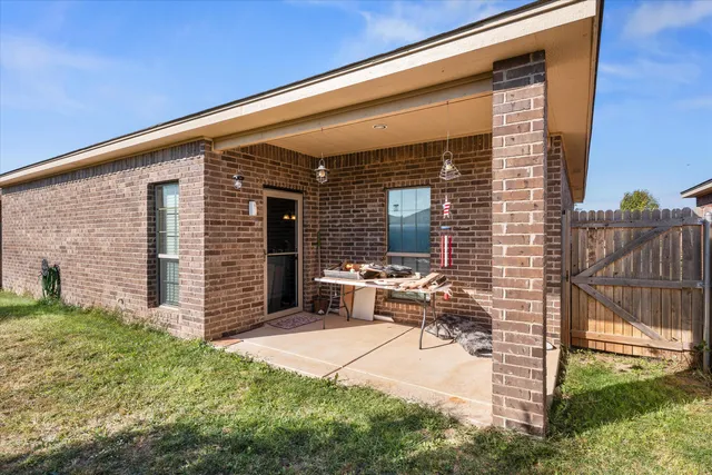 a view of backyard with a large tree