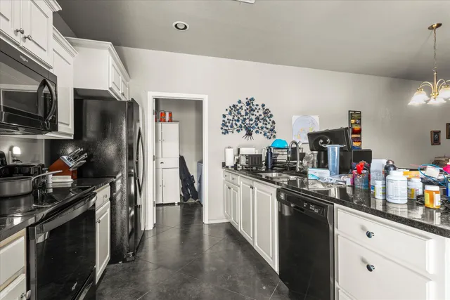 a kitchen with stainless steel appliances a sink stove and refrigerator