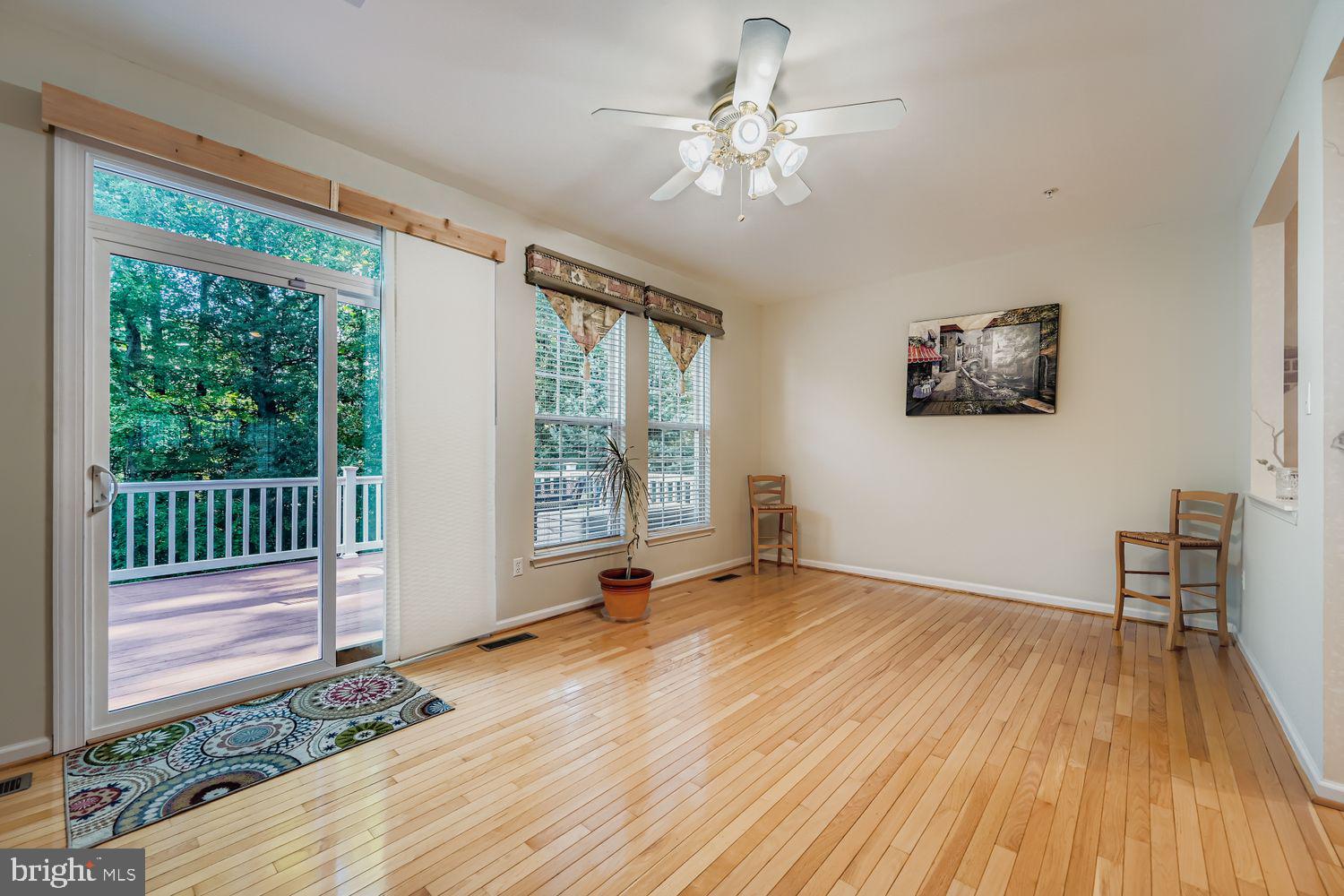 9809 Redwing Drive, Unit 9809 Perry Hall, MD 21128 - Photo 12 of 42 a view of an empty room with a window and wooden floor