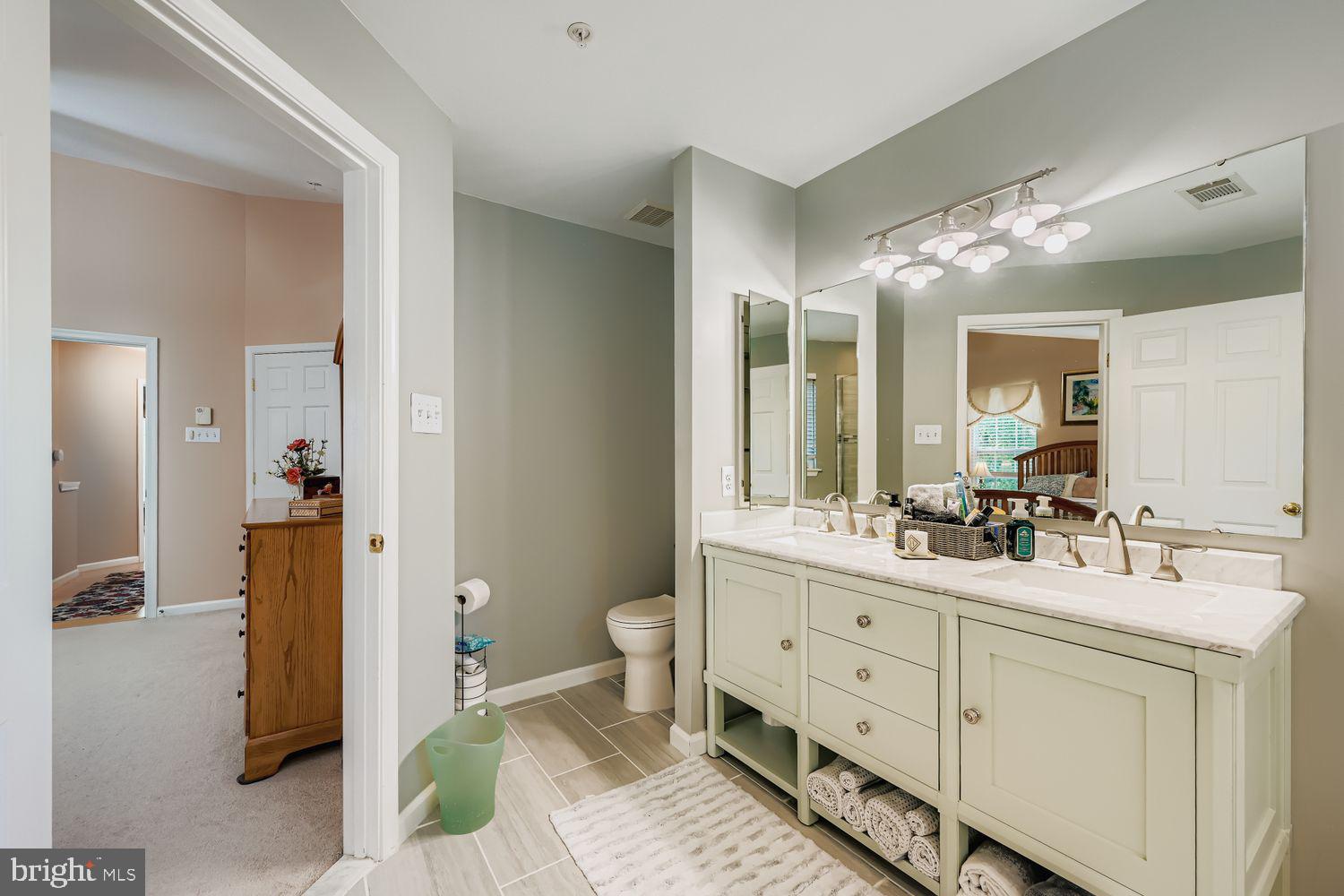 9809 Redwing Drive, Unit 9809 Perry Hall, MD 21128 - Photo 17 of 42 a spacious bathroom with double vanity and a mirror